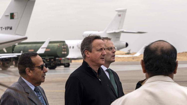 British Foreign Secretary David Cameron meets the delegation from the British Embassy in Cairo at Al-Arish airport in Egypt to inspect humanitarian aid destined for Gaza, on 21 December 2023.