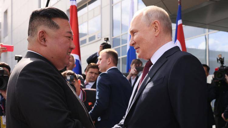 Russia's President Vladimir Putin shakes hands with North Korea's leader Kim Jong Un.