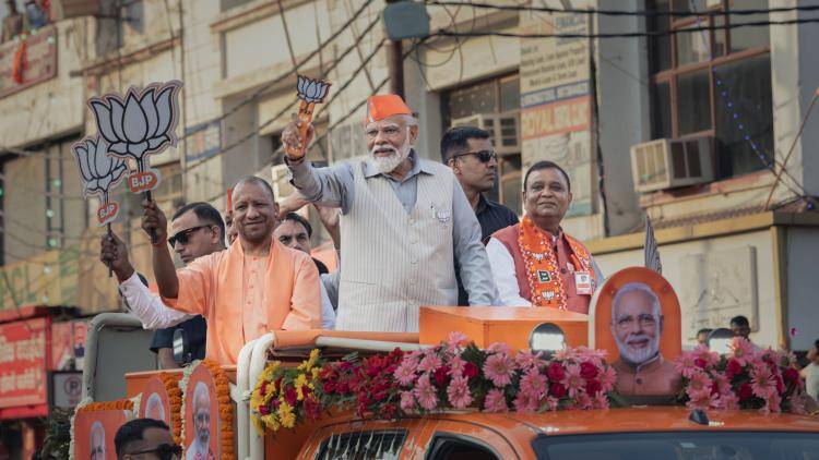 Prime Minister Narendra Modi greets supporters at a roadshow on 6 April 2024 in Ghaziabad, Uttar Pradesh, India.